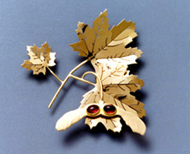 gold maple leaf brooch with mi-precious stones